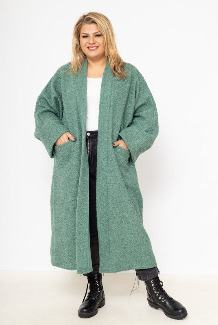 Le gilet long bouclé
